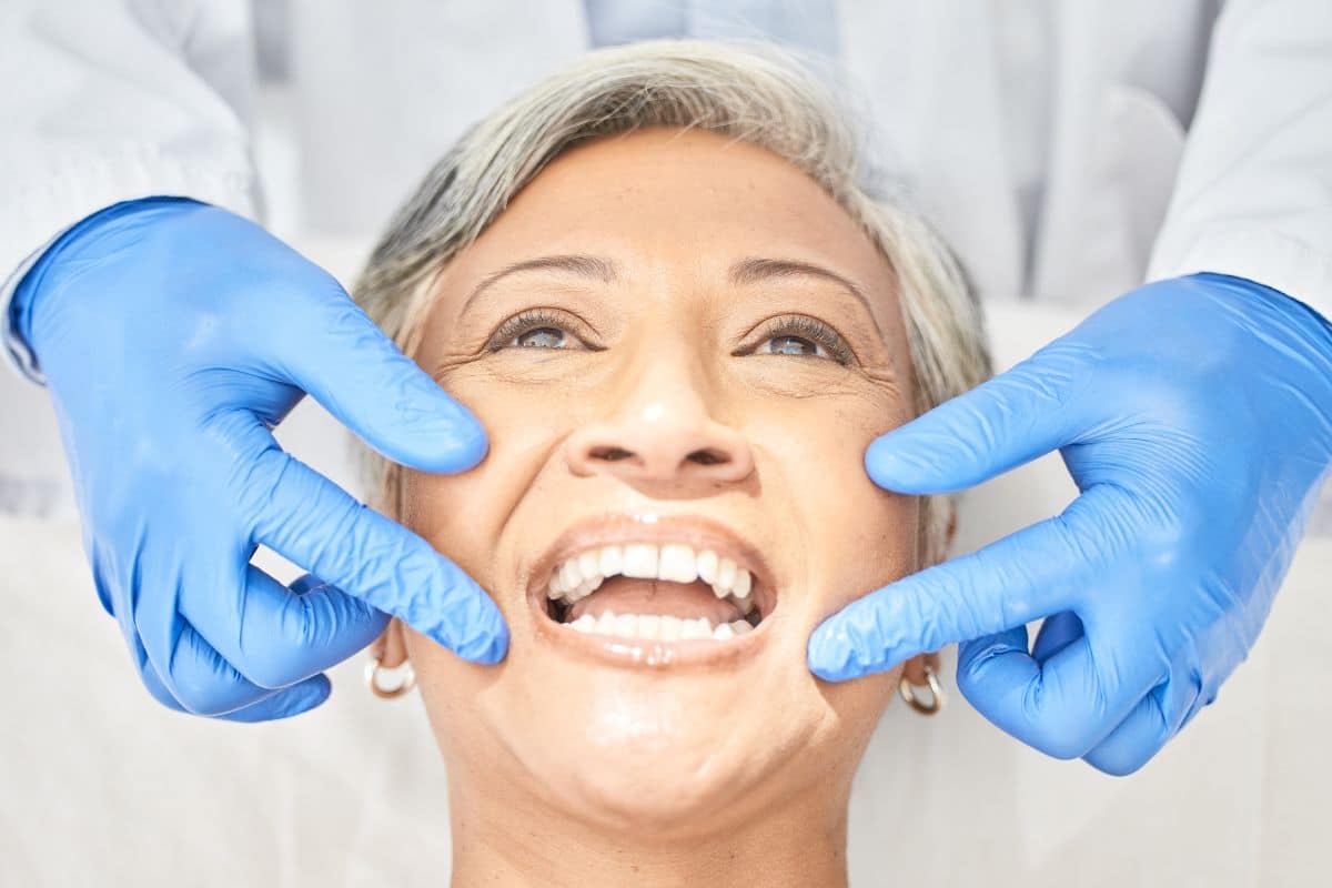 an older woman smiling after getting veneers in Gainseville, TX, at Saddlebrook Dental and Orthodontics