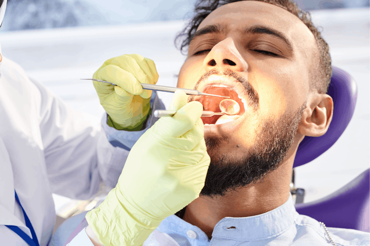 Dentist examining patient's teeth during orthodontic consultation in Gainesville.